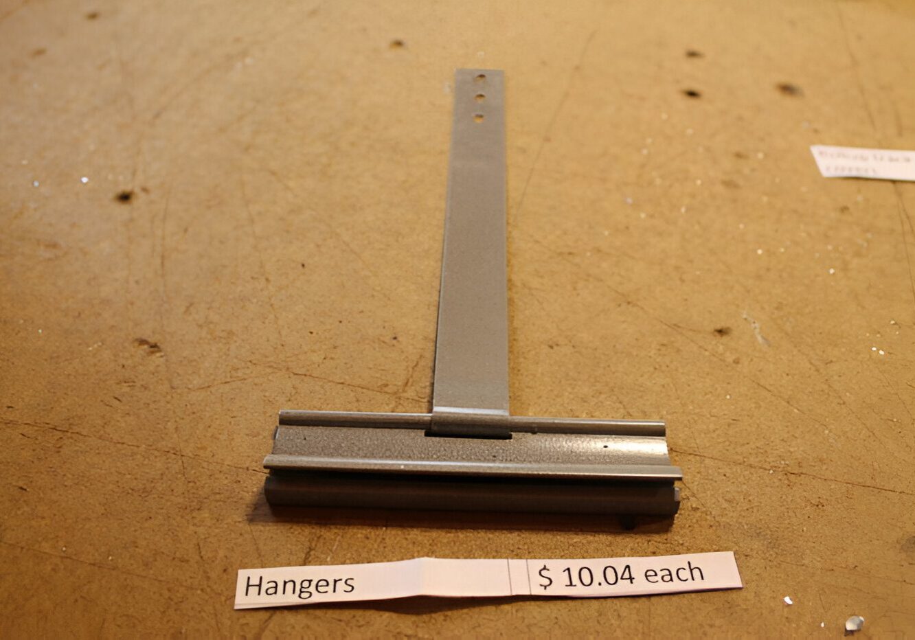 Metal hanger displayed with price tag.