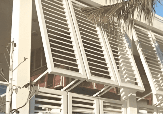 Building with open white window shutters.