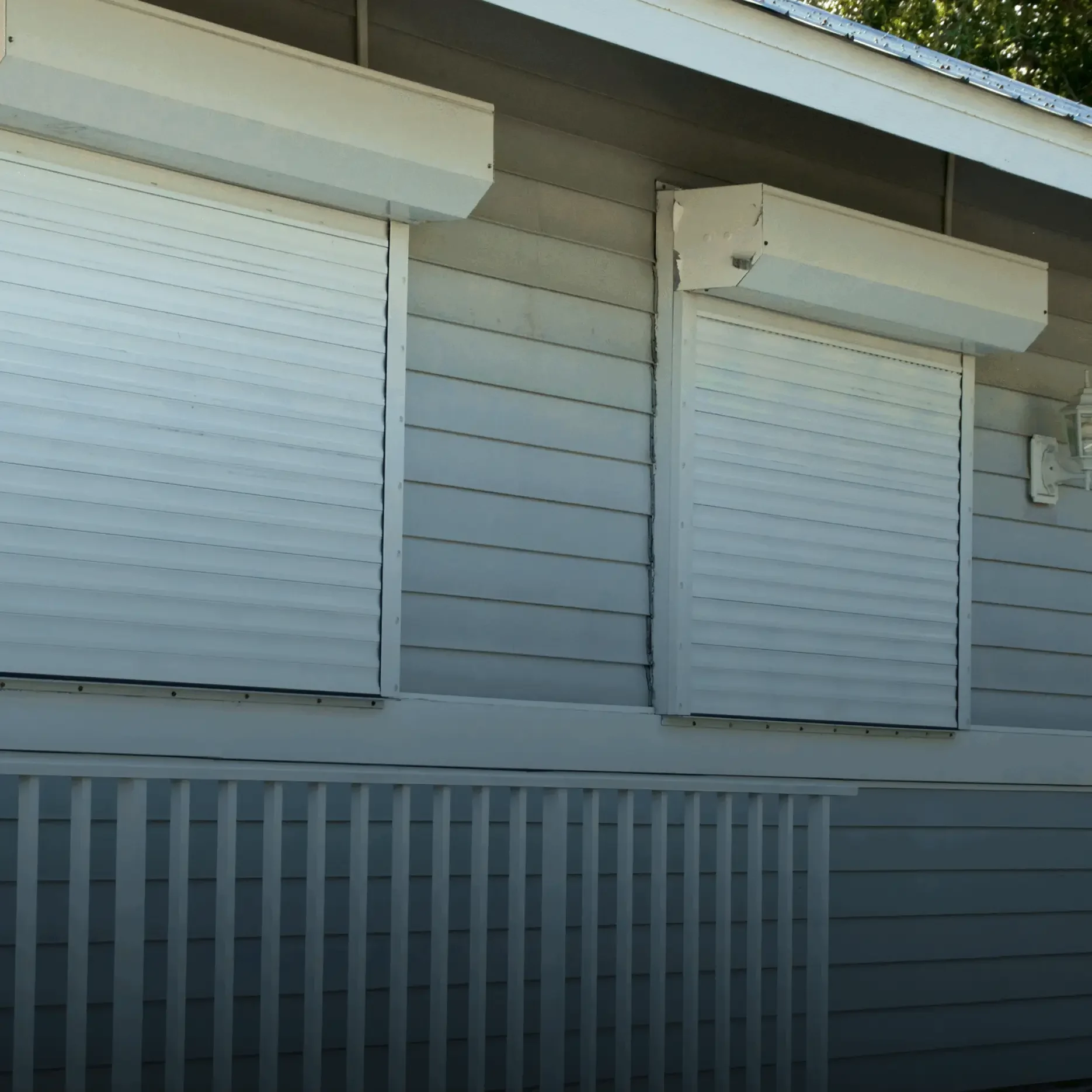 House with closed white window shutters.